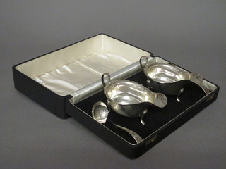 A pair of silver sauce boats with C scroll handles together with  a pair of Old English pattern sauce ladles, Sheffield 1959 and  1960, 7 ozs, cased  ILLUSTRATED