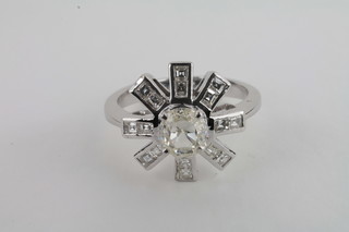 A lady's 18ct white gold dress ring set a diamond surrounded by  8 bars of diamonds in the form of a star, approx 1.61ct