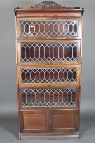 An Edwardian mahogany 5 tier Globe Wernicke style bookcase  enclosed by lead glazed panelled doors, the base fitted a double  cupboard enclosed by panelled doors 34"   ILLUSTRATED