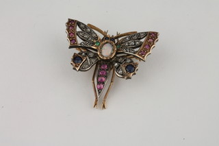 An attractive gold bar brooch in the form of a dragonfly set  diamonds, rubies and sapphires