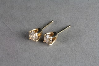 A pair of 14ct yellow gold diamond set ear studs, approx 0.50ct