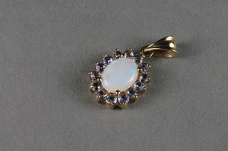 A 9ct gold pendant set an opal surrounded by diamonds