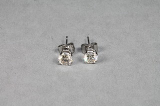 A pair of 14ct white gold diamond ear studs, approx 1.20ct in  total,
