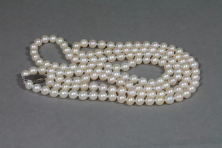 A double rope of cultured pearls with diamond clasp