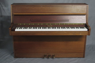 A modern iron framed upright piano forte by Eavestaff,  contained in a teak case 55 1/2"