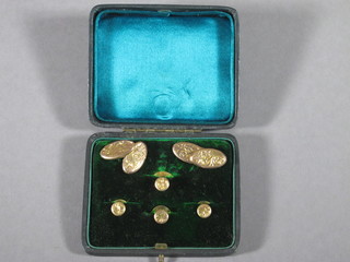 A pair of oval 9ct gold and engraved cufflinks together with 4  studs, cased