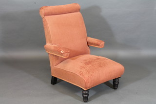 A Victorian mahogany framed armchair upholstered in pink material