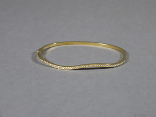 A gilt metal bracelet set white stones