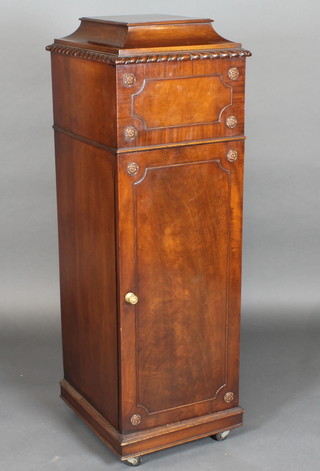A Georgian style mahogany pedestal with hinged lid fitted a cupboard enclosed by a panelled door 16"