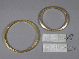 2 gilt metal bangles and a pair of carved mother of pearl earrings formed from game counters