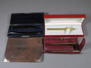 A Schaeffer box containing a Pierre Cardin pen and a gold plated Steico ball point pen and a 9ct Yard-o-led pencil, a silver mounted leather wallet and a pair of cut throat razors