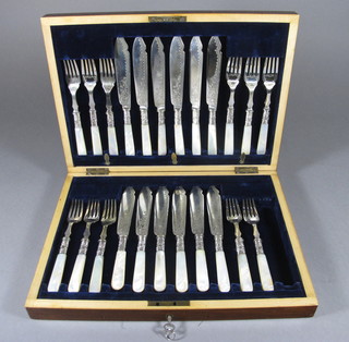 A set of 12 Victorian silver plated fish knives and forks with mother of pearl handles contained in a walnut canteen box