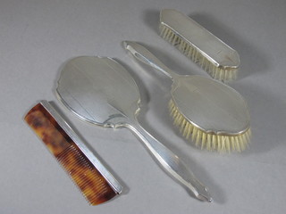 A 4 piece silver backed dressing table set comprising hair brush, clothes brush, comb and hand mirror