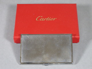 A Cartier stainless steel card case, boxed and complete with carrier bag