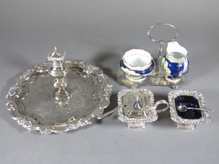 A circular silver plated salver, a large 3 piece silver plated  condiment set and a silver plated cream and sugar stand