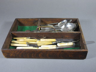 A collection of silver plated flatware contained in an oak cutlery  tray