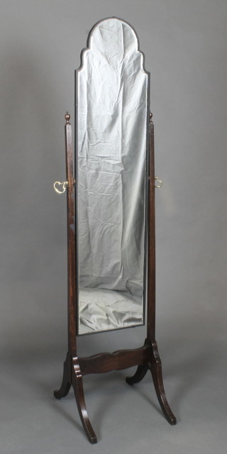 A cheval mirror contained in an oak swing frame