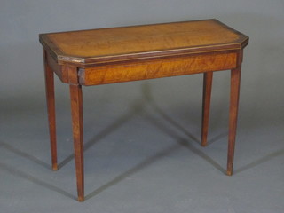 A 19th Century lozenge shaped card table raised on square  tapering supports 36"