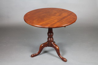 A 19th Century circular mahogany tea table, raised on pillar and tripod supports 30"