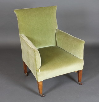 A mahogany framed armchair upholstered in green material