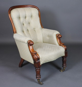 A Victorian mahogany show frame armchair upholstered in green material