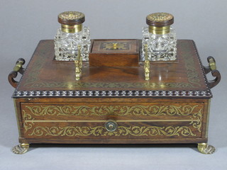 A handsome Regency rosewood and brass inlaid standish with 2 cut glass inkwells and pen rest, raised on brass feet 12"   ILLUSTRATED