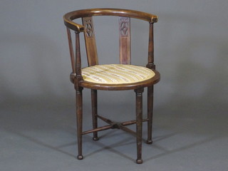 An Edwardian inlaid mahogany tub back chair, raised on turned supports