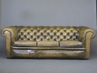 A Chesterfield upholstered in green buttoned leather 86"