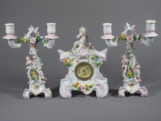 A Continental 3 piece clock garniture with Arabic numerals contained in a porcelain case surmounted by a figure of a cherub  - f and r, together with a pair of twin light candelabrum - f and r,