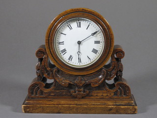 A 19th Century time piece with enamelled dial and Roman  numerals contained in an oak case, back plate marked R & Co,  contained in a carved wood case