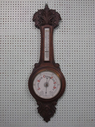 A Victorian aneroid barometer and thermometer with porcelain  dial contained in a carved oak case, glass cracked,