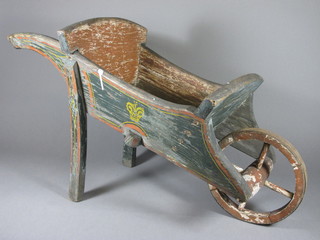 A painted wooden wheel barrow 29"