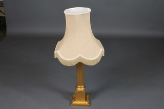 A gilt painted reeded table lamp, raised on a square base 21"