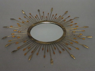A circular plate wall mirror contained in a gilt metal sunburst frame 17"