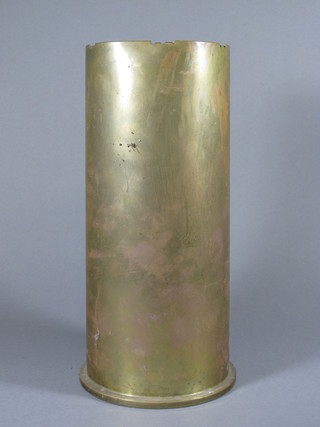 A large brass shell case, the base marked 398