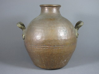 An Eastern planished copper twin handled jar 15"