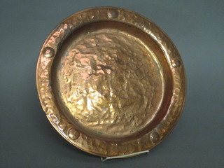 A circular planished Art Nouveau copper dish 14"