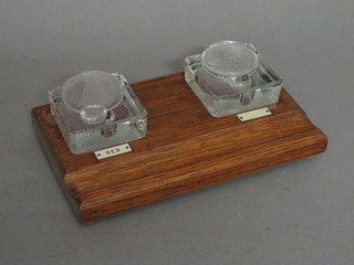 A rectangular oak standish fitted 2 square glass inkwells with lids 10"