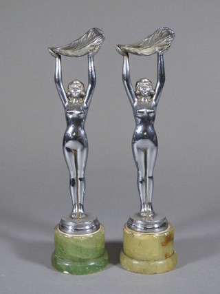 A pair of Art Deco chrome figures of standing naked ladies, raised on marble bases  ILLUSTRATED