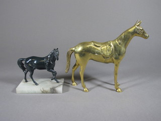 A brass figure of a standing saddle horse 9" and a green metal figure of a horse raised on a marble base 6"