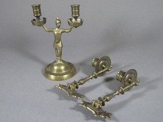 A brass twin light candelabrum supported by a figure 8" and 2  brass candle sconces