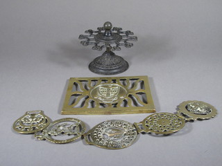 A circular revolving iron rubber stamp stand 4", a pierced brass plaque decorated the Arms of Cambridge University and 5 horse  brasses