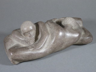 A carved stone sculpture of 2 reclining figures 7"