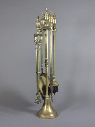 A brass 4 piece fireside companion set comprising shovel, poker,  brush and tongs