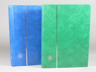 A blue stock book of various World stamps and a green stock  book of World stamps
