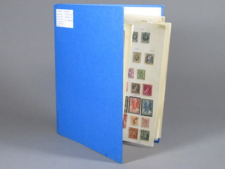 A blue loose leaf album of various stamps