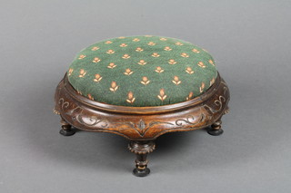 A Victorian circular carved walnut stool raised on turned supports with upholstered seat 12"