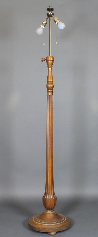 An Edwardian turned and fluted walnut standard lamp