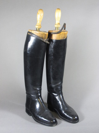A pair of black leather riding boots complete with wooden trees  by Tom Hill of London