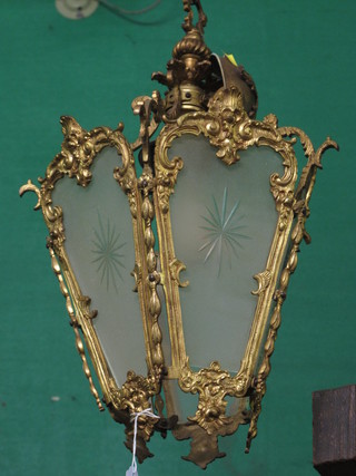 A gilt metal and glass hanging lantern